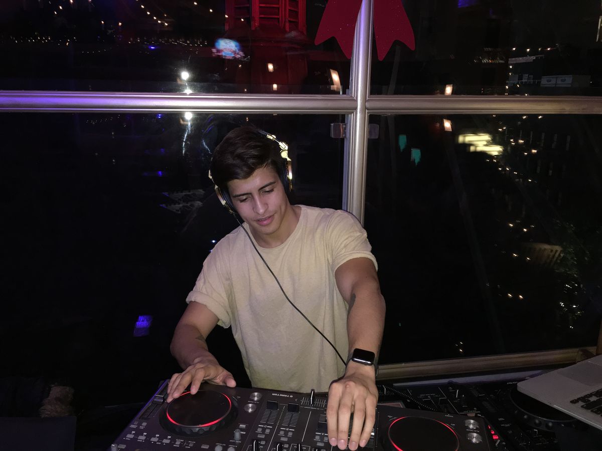 Vallber DJing at a rooftop night session